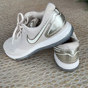 Nike gold and cream tennis shoes